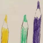 A drawing of the top half of a red, yellow, green and purple colouring pencil. They have been drawn iin colouring pencil.