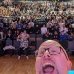 Selfie of Kalle Ryan , roaring happily, with a theatre filled with 200+ international students at International Digital Marketing Week 2025. He was delivering a creative workshop