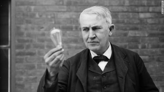 B&W photo of Thomas Edison holding a lightbulb